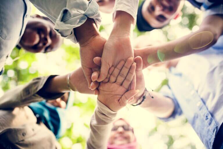 Group of diverse youth hands joined